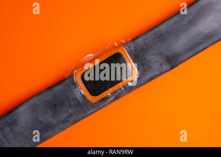 Patch on the camera of the bike. bicycle repair kit, wheels camera on wooden background Stock Photo