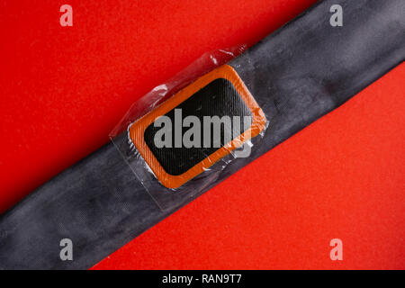 Patch on the camera of the bike. bicycle repair kit, wheels camera on wooden background Stock Photo