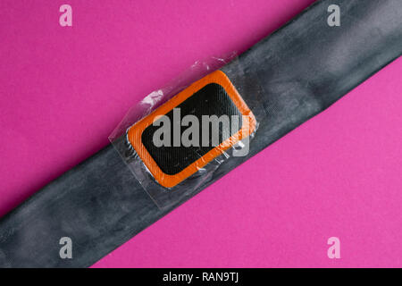 Patch on the camera of the bike. bicycle repair kit, wheels camera on wooden background Stock Photo