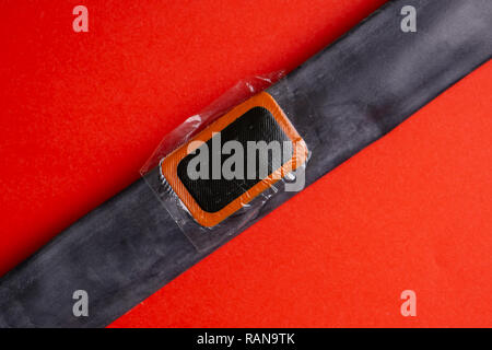 Patch on the camera of the bike. bicycle repair kit, wheels camera on wooden background Stock Photo