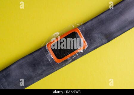 Patch on the camera of the bike. bicycle repair kit, wheels camera on wooden background Stock Photo