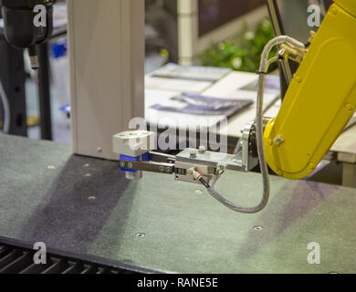 Robotic arm loading workpiece to CNC CMM Coordinate Measuring Robotic Stock Photo