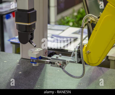 Robotic arm loading workpiece to CNC CMM Coordinate Measuring Robotic Stock Photo