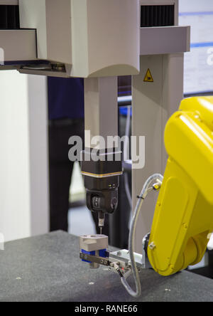 Robotic arm loading workpiece to CNC CMM Coordinate Measuring Robotic Stock Photo