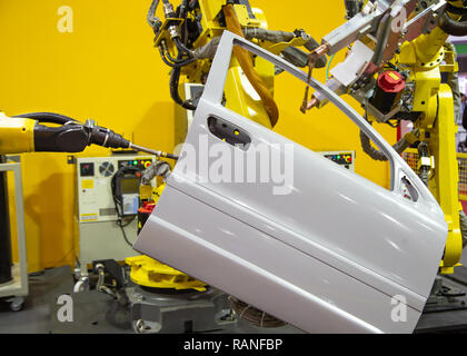 Robot arm demonstrate spot welding car door Stock Photo