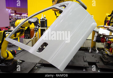 Robot arm demonstrate spot welding car door Stock Photo