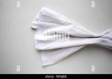 White folded cotton textile isolated on white background Stock Photo