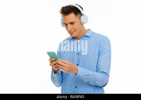 Delighted nice man looking at the smartphone screen Stock Photo