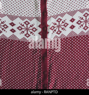 Knitted woolen background. white and red knitted Norwegian pattern. Stock Photo