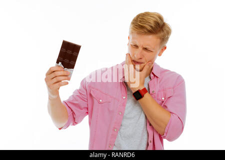 Nice pleasant young man feeling strong pain Stock Photo