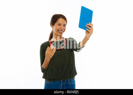Happy nice young woman taking a selfie Stock Photo