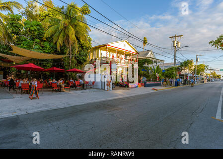 View of Duval Street in Key West, Florida, with shops, restaurants, hotels and guesthouses ornate with Christmas decorations. Stock Photo