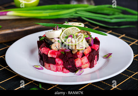 Salad with sprats, beets, potatoes and quail eggs. Stock Photo