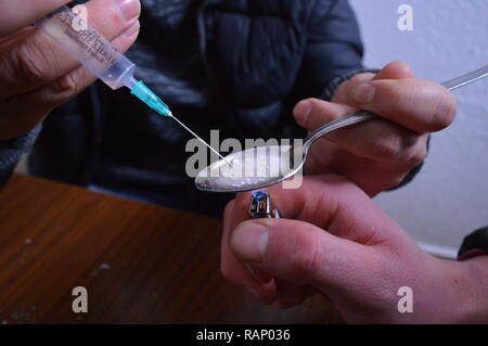 Heroine being prepared by heating it up in a spoon Stock Photo
