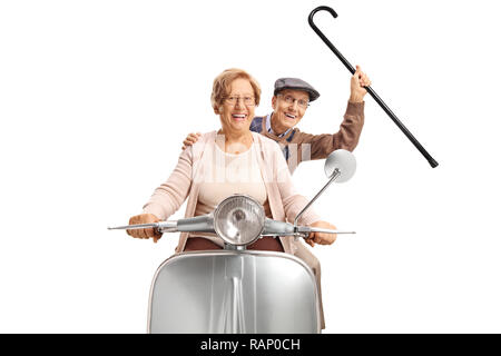 Cheerful senior couple riding a vintage scooter and holding a cane up isolated on white background Stock Photo