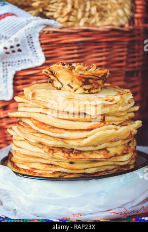 A beautiful stack of fresh pancakes at the feast at the Spring Festival Maslenitsa in Belarus Stock Photo