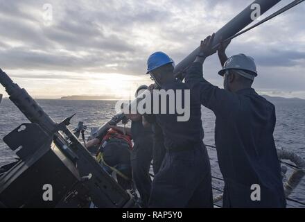 GUAM (Feb. 23, 2017) Sailors aboard Arleigh Burke-class guided-missile destroyer USS Michael Murphy (DDG 112) raise the jack staff before mooring into Naval Base Guam. The jack staff is the flagpole at the bow of the ship that flies the Union Jack flag. Michael Murphy is on a regularly scheduled Western Pacific deployment with the Carl Vinson Carrier Strike Group as part of the U.S. Pacific Fleet-led initiative to extend the command and control functions of U.S. 3rd Fleet. U.S. Navy aircraft carrier strike groups have patrolled the Indo-Asia-Pacific regularly and routinely for more than 70 yea Stock Photo