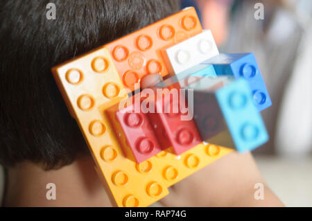 Boy playing with lego construction toy blocks. Stock Photo