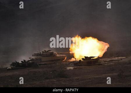 An M1A1 Abrams tank assigned to Delta Company, 1st Tank Battalion, fires down range during Integrated Training Exercise (ITX) 2-17 aboard Marine Corps Air Ground Combat Center, Twentynine Palms, California, Feb. 16, 2017. ITX is a combined-arms exercise which gives all elements of the Marine Air Ground Task Force an opportunity to utilize capabilities during large scale missions to become a more ready fighting force. 1/3 is currently participating as the ground combat element for this exercise. Stock Photo