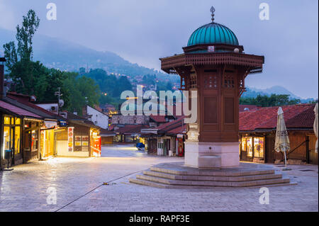 Illuminated Sebilj ottoman-style wooden fountain at sunrise, Bascarsija old bazar, Sarajevo, Bosnia and Herzegovina Stock Photo