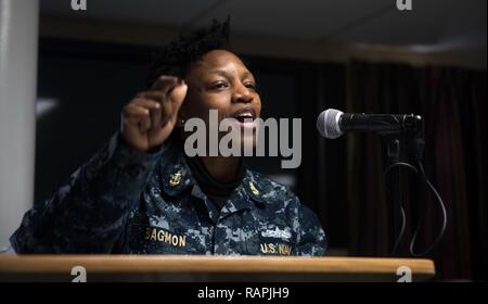 BREMERTON, Washington (Feb. 24, 2017) Chief Legalman Tanica Bagmon from Fort Washington, Maryland, gives a speech during USS John C. Stennis’ (CVN 74) African American/Black History Month celebration aboard a berthing barge used to provide living and workspace as well as basic services during the ongoing maintenance period. John C. Stennis is conducting a planned incremental availability (PIA) at Puget Sound Naval Shipyard and Intermediate Maintenance Facility, during which the ship is undergoing scheduled maintenance and upgrades. Stock Photo