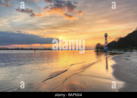 Sunset at River Elbe lighthouse and beach in Wittenbergen Hamburg Stock Photo