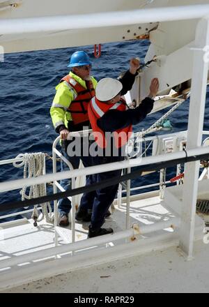 ATLANTIC OCEAN (February 21, 2017)--Chief Andrew Chen, a Civil Service Mariner attached to Military Sealift Command's hospital ship USNS Comfort (T-AH 20) secures a lifeboat after an abandon ship drill aboard the vessel, Feb. 21. Comfort was at sea for its Comfort Exercise (COMFEX). Stock Photo