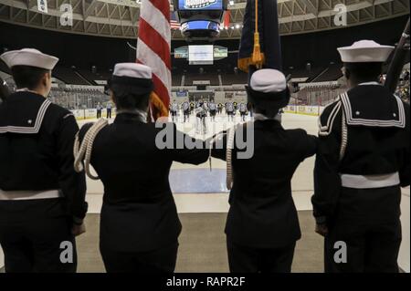 NORFOLK (Feb. 25, 2017) Members of the Nimitz-class aircraft carriers USS Abraham Lincoln (CVN 72) and USS Dwight D. Eisenhower (CVN 69) hockey teams stand on the ice during the national anthem. The Lincoln and Eisenhower hockey teams faced off at the Norfolk Scope arena in support of the Navy Marine Corps Relief Society. Stock Photo