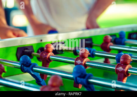 Sport Football Game Playing on Table Soccer controlling players with arms Stock Photo