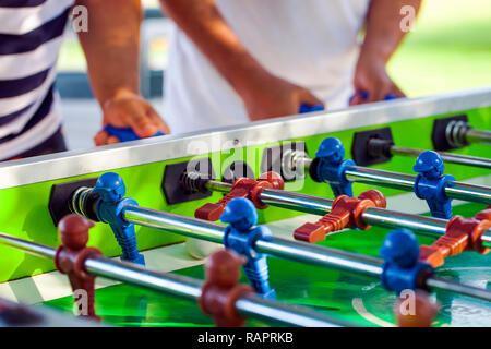 Sport Football Game Playing on Table Soccer controlling players with arms Stock Photo