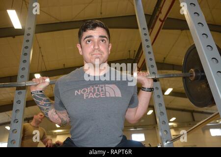 SILVERDALE, Wash. (Feb. 28, 2017) – Machinist Mate 1st Class Nick Wheeler gives a back squat demonstration on the new Navy Operational Fitness and Fueling Systems (NOFFS) gym equipment at Naval Base Kitsap (NBK) – Bangor. Stock Photo