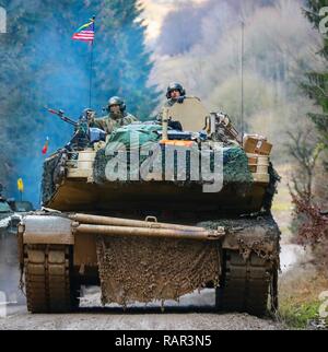 A U.S. Army M1A1 Abrams tank crew from 2nd Battalion 7th Cavalry Regiment, 1st Armored Brigade Combat Team, 1st Cavalry Division maneuver to position their tank in advance of their next mission during exercise Combined Resolve XI in Hohenfels, Germany, Dec. 10, 2018. CBRXI at the Joint Multinational Readiness Center is the final exercise in 1-1 CD’s rotation in support of Atlantic Resolve in Europe, which evaluates the interoperability of U.S. Forces with their NATO allies and partners. Stock Photo