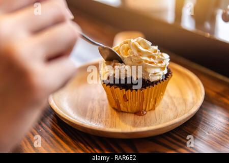 Eating cream cup cake sugar sweet delicious fat unhealthy food. Stock Photo