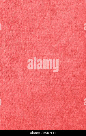 Background texture of old fabric book cover in warm pink coral hue. Stock Photo