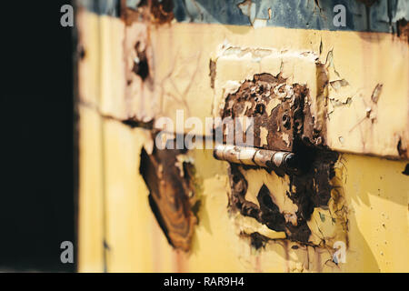Flaking paint on an old locomotive access panel. Stock Photo