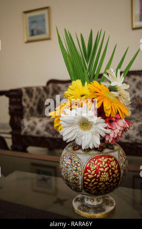 Gerbera different colors in an old Indian-style vase in the interior Stock Photo