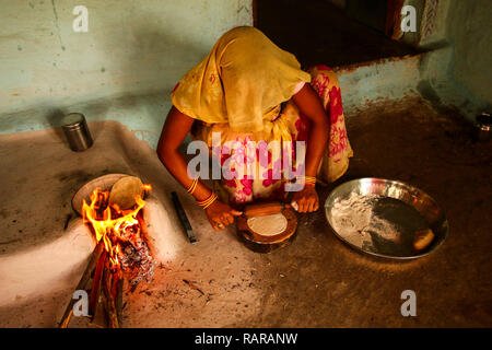 Traditional way of making food cooking on open fire in a rural village,near Kajiraho,India Stock Photo