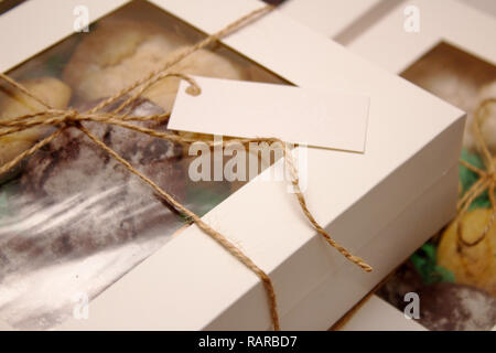 packed boxes with cookies tied with rope Stock Photo