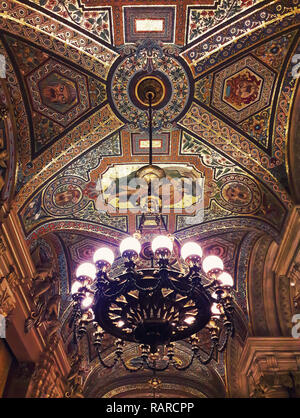 Breathtaking painted ceiling inside Opera Garnier palace in Paris France and a beautiful chandelier suspend. Stock Photo