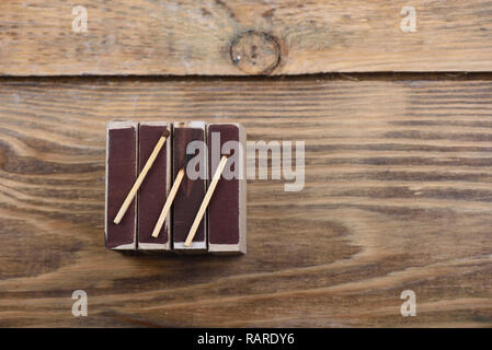 A burnt match and two whole matches on matchboxes Stock Photo