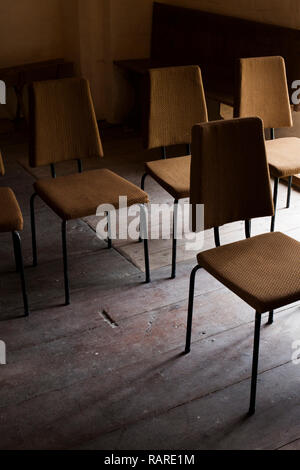 Chairs in a row in an old church Stock Photo