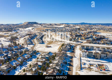 A great photo illustrating Denver urban sprawl and the Colorado housing boom as it continues even in the winter snow Stock Photo