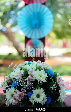 MERIDA, YUC/MEXICO - NOV 18, 2017: Twin babies's baptismal party venue decoration and gifts for guests. Bouquet of flowers Stock Photo