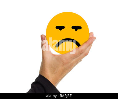 Hand holding a yellow circle with face expression sad illustration. Stock Photo