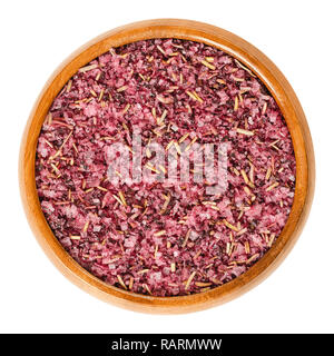 Fleur de Sel with dried hibiscus blossoms and rosemary in wooden bowl. Purple colored salt to flavor and garnish food. Stock Photo
