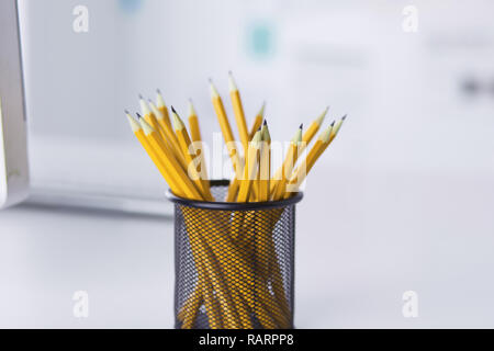 Graphite pencils in a metal grid-container. Concept. Stock Photo