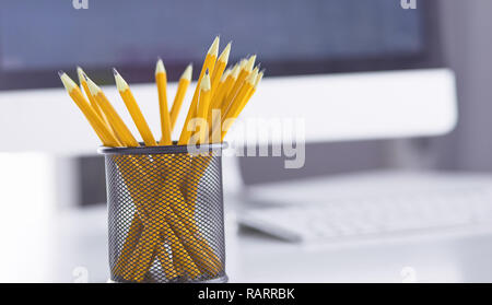Graphite pencils in a metal grid-container. Concept. Stock Photo