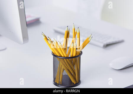 Graphite pencils in a metal grid-container. Concept. Stock Photo