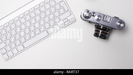 Computer keyboard, mouse and camera lie on table. Stock Photo