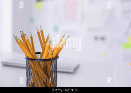 Graphite pencils in a metal grid-container. Concept. Stock Photo
